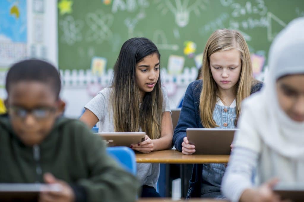 Two girls using tablets