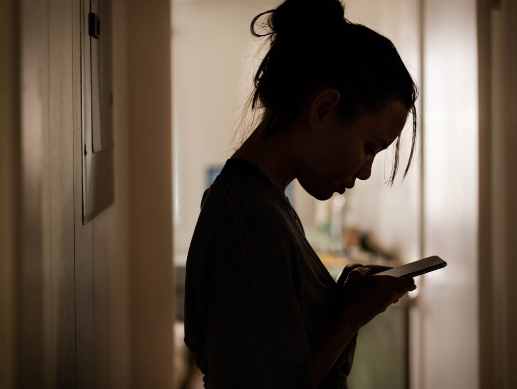 silhouette of girl on her phone