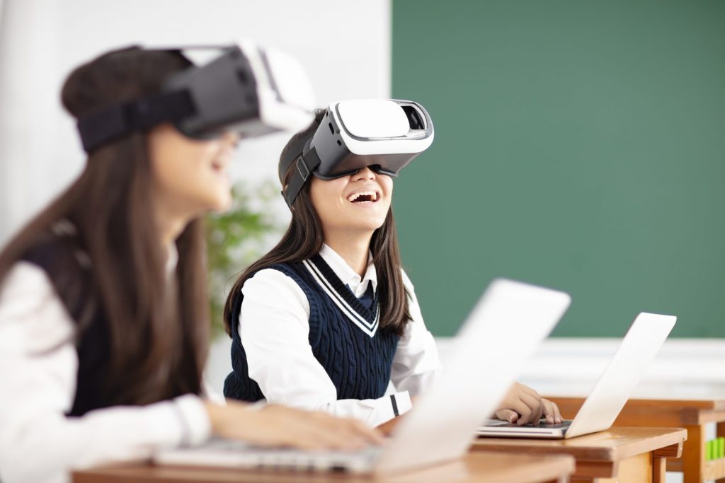 2 high school girls using mobile devices and VR
