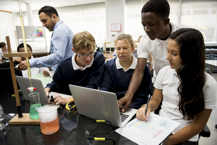High school children using technology in a science class