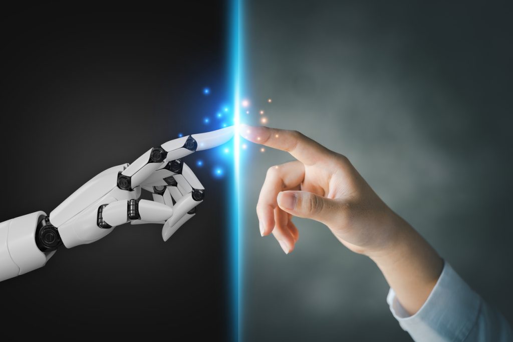 Robot and human hands pointing to each other, the idea of creating futuristic AI, intelligent systems to work instead of humans and do what humans can't. Creating innovative technology of the future. stock photo